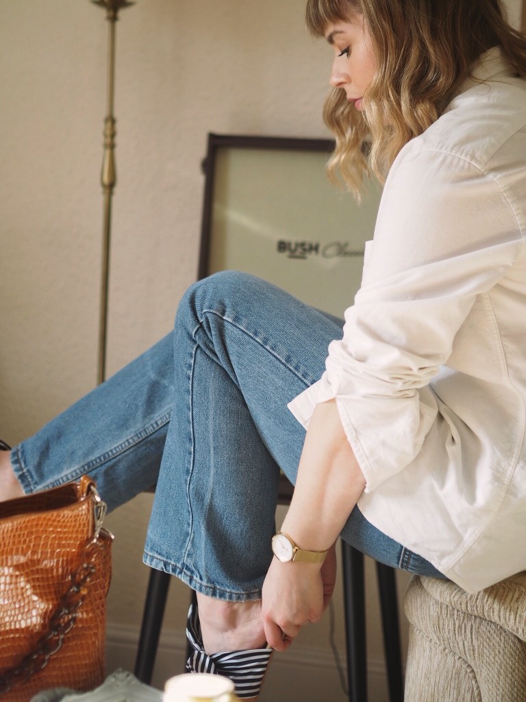Elevated basics outfit - blue jeans, oversized white shirt and gold details